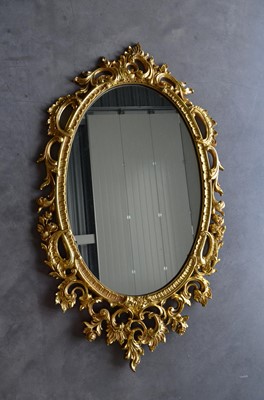 Lot 64 - A 20th Century Rococo style oval wall mirror