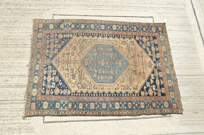 Lot 142 - A Middle Eastern wool rug with a central rosette