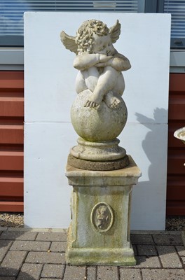 Lot 169 - A reconstituted stone sculpture of a cherub