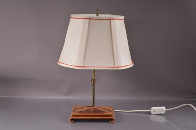 Lot 191 - An adjustable brass table lamp with an oriental hardwood stand