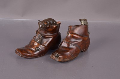 Lot 223 - Two metal figures of boots with climbing animals