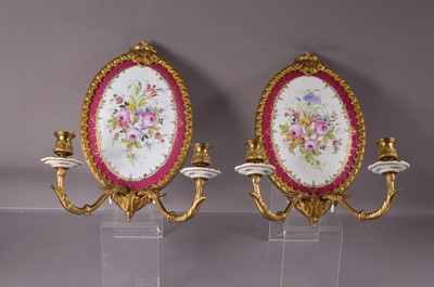 Lot 317 - A pair of French ormolu and porcelain twin-branch wall light sconces