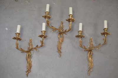 Lot 318 - A set of three French rococo Louis XV style twin-branch gilt metal wall lights