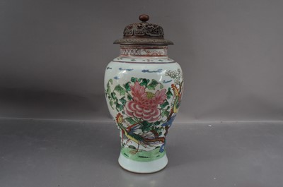 Lot 332 - A Chinese Wucai porcelain vase with a carved hardwood cover