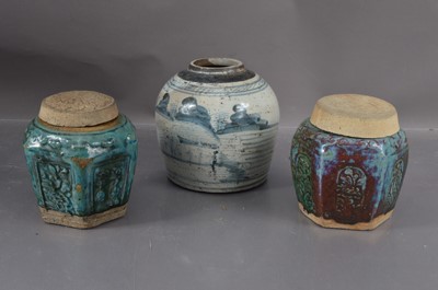 Lot 335 - Two Chinese moulded eathenware Shiwan pottery ginger jars and covers