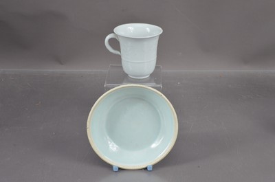 Lot 351 - A blanc de chine porcelain cup and a celadon glazed saucer