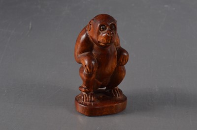 Lot 371 - A Japanese boxwood netsuke in the form of a seated monkey