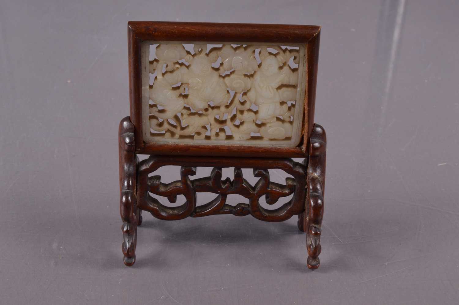 Lot 379 - A Chinese reticulated jade plaque mounted as a miniature table screen