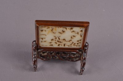 Lot 379 - A Chinese reticulated jade plaque mounted as a miniature table screen