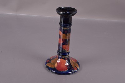 Lot 515 - A Moorcroft Pottery candlestick in 'Fruit and Berries' pattern