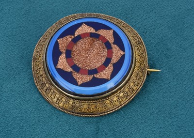 Lot 11 - A 19th century inlaid and base metal target brooch of circular design