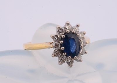 Lot 85 - An 18ct gold sapphire and diamond cluster ring