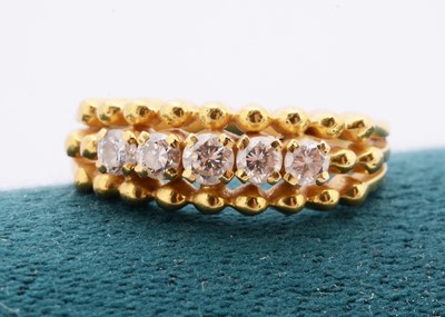 Lot 138 - A continental yellow metal five stone diamond dress ring