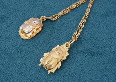 Lot 172 - Two continental yellow metal scarab beetle pendants and chains