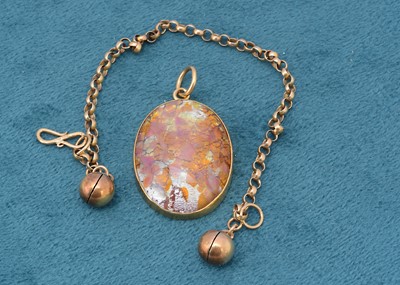 Lot 173 - A Far Eastern yellow metal and resin pink pendant