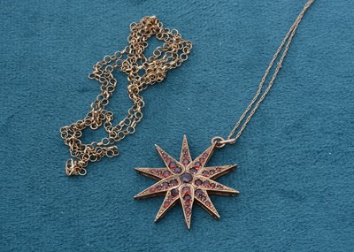 Lot 189 - A 9ct gold garnet star pendant on a fine gold chain