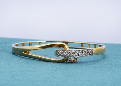 Lot 247 - An 18ct gold and diamond bangle