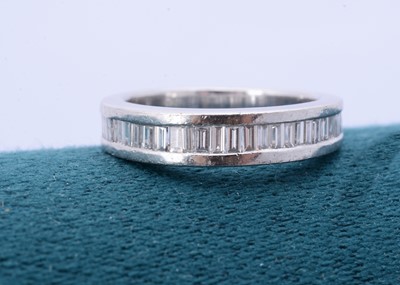 Lot 262 - A platinum diamond half hoop eternity ring