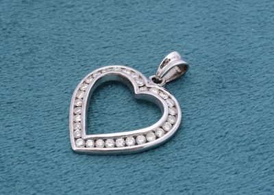 Lot 264 - A 9ct white gold and diamond set open heart pendant