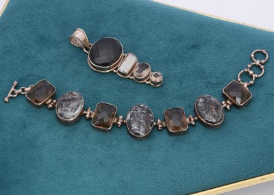 Lot 297 - A smokey quartz and hardstone silver set bracelet