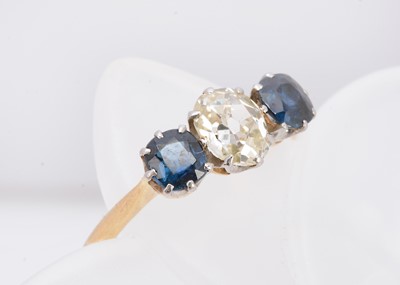 Lot 369 - A three stone 18ct gold and platinum diamond and sapphire ring