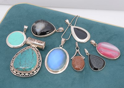 Lot 374 - A collection of hardstone silver framed pendants