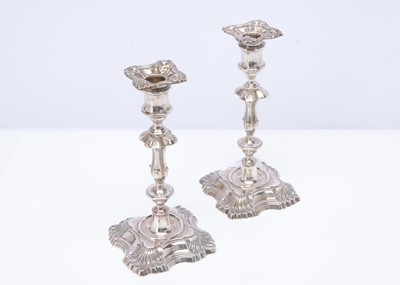 Lot 472 - A pair of George V silver and filled candlesticks retailed through Harrods