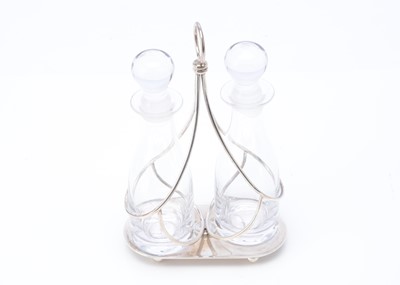 Lot 477 - A modern silver bottle stand and pair of cruet bottles