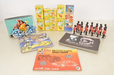 Lot 393 - Ex Shop/Sales Rep Enid Blyton Noddy Egg Cups and Bassett-Allsorts  Books and Collectors Card Album Timpo Soldiers with tinplate friction Motorbike and Pop-Pop boat (qty).