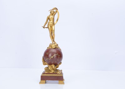 Lot 21 - A late 19th century French bronze and red marble figural clock