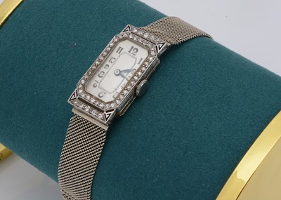 Lot 133 - A c1950s platinum and diamond lady's cocktail dress wristwatch case