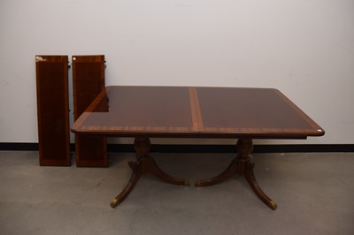 Lot 30 - A modern reproduction mahogany twin pedestal extending dining table