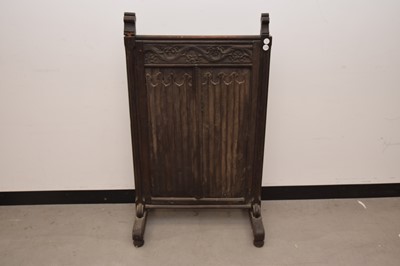 Lot 37 - An antique carved oak fire screen