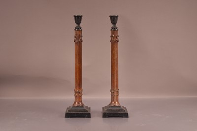 Lot 151 - A pair of late Victorian or Edwardian metal candlesticks