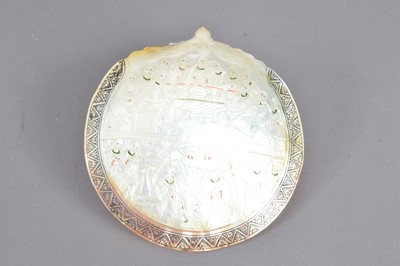 Lot 169 - An antique carved mother-of-pearl devotional plaque or baptismal spoon