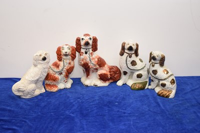 Lot 450 - Five Staffordshire pottery dogs