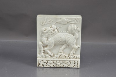 Lot 477 - A antique Chinese white glazed dragon tile