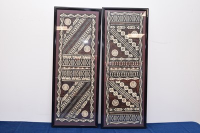 Lot 593 - A pair of framed vintage tribal printed paper decorations