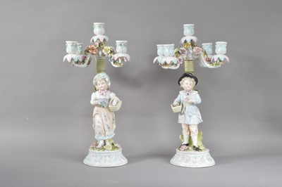 Lot 21 - A pair of 20th century continental porcelain four branch candelabra's