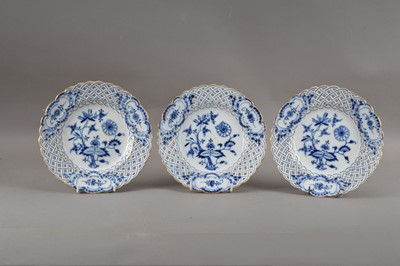 Lot 63 - Three turn of the century Meissen porcelain reticulated plates, blue and white foliate design with gilt edges, printed marks and partially impressed numbers to the undersides, all 20.5cm diameter (3)