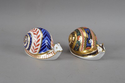 Lot 80 - Two Royal Crown Derby bone china snail paperweights
