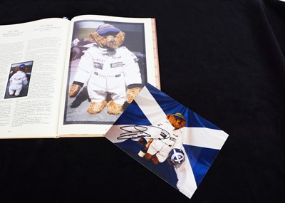 Lot 214 - A signed photograph of a Marie Robischon Teddy Bear by racing driver David Coulthard