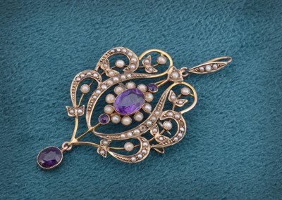 Lot 48 - An Edwardian art nouveau amethyst and seed pearl pendant or brooch