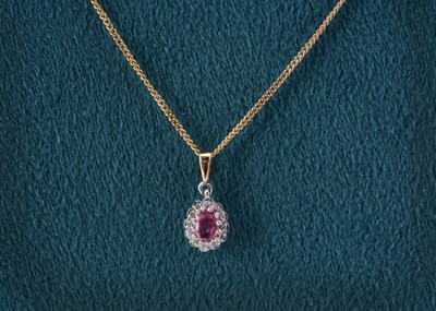 Lot 77 - A 9ct gold pink sapphire and diamond set oval pendant