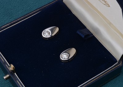 Lot 92 - A pair of platinum and diamond set ear studs