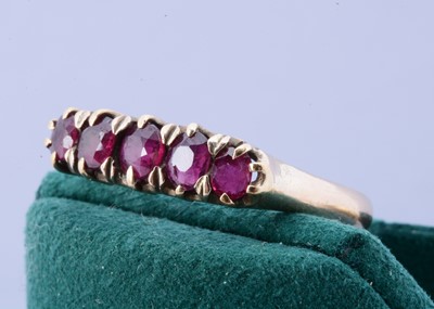 Lot 98 - A yellow metal five stone ruby dress ring