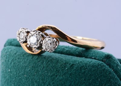 Lot 100 - An 18ct and platinum Bravingtons crossover diamond dress ring