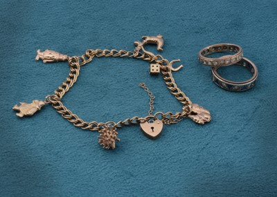 Lot 105 - A 9ct gold charm bracelet set with various novelty and comical charms