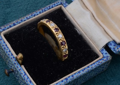 Lot 109 - An 18ct gold ruby and diamond half hoop eternity ring