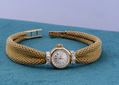 Lot 125 - A Corum 18ct gold and diamond set lady's wristwatch